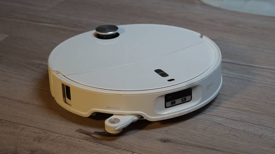 the Roborock Qrevo Curv 2 Pro robot vacuum cleaner on a wooden floor.