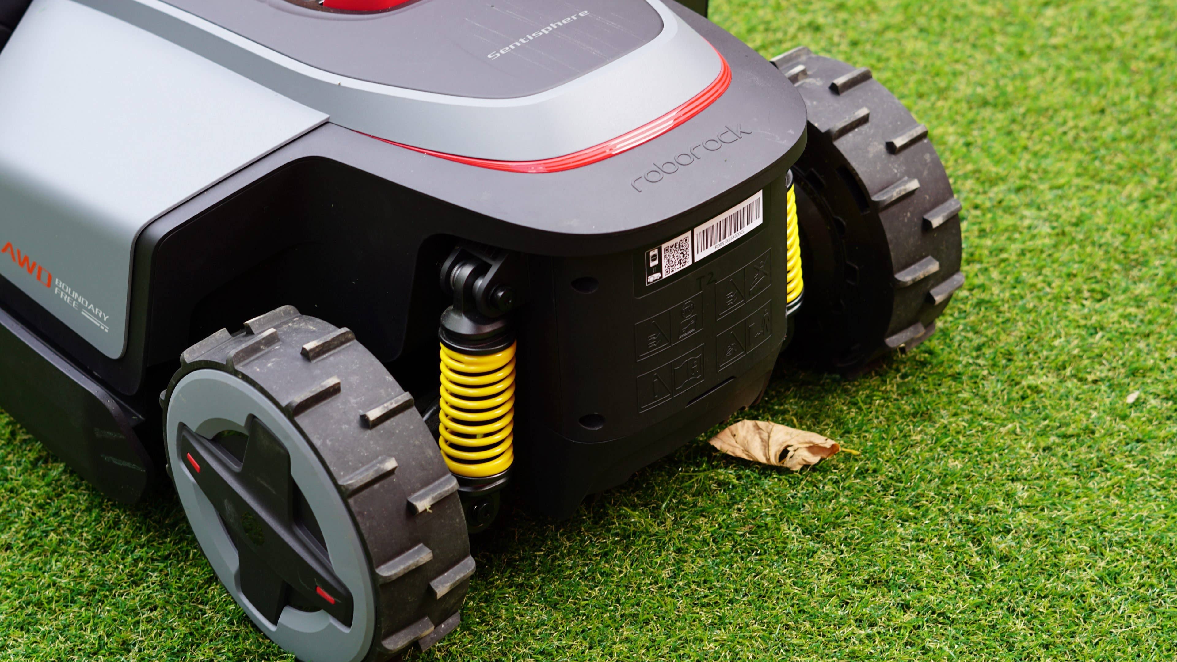 Roborock RockMow Z1 robotic lawn mower on green grass, with visible wheels and features. Roborock RockMow Z1 robotic lawn mower on green grass, with visible wheels and features.