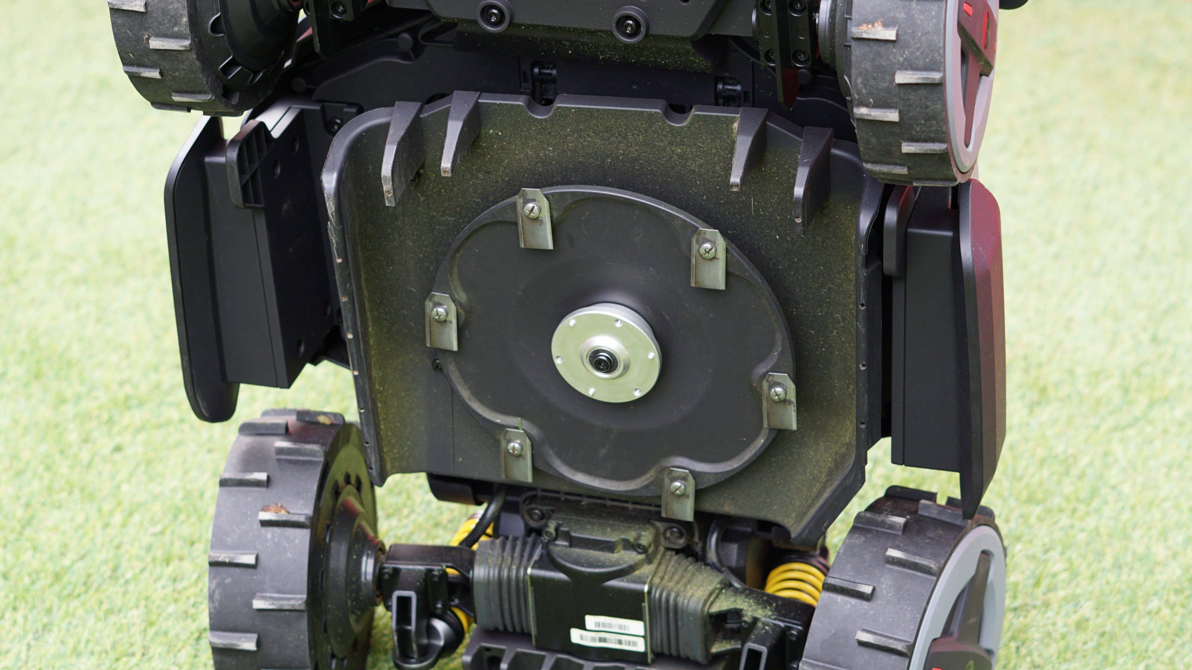 Roborock RockMow Z1 robotic mower with visible wheels and underside components. Roborock RockMow Z1 robotic mower with visible wheels and underside components.