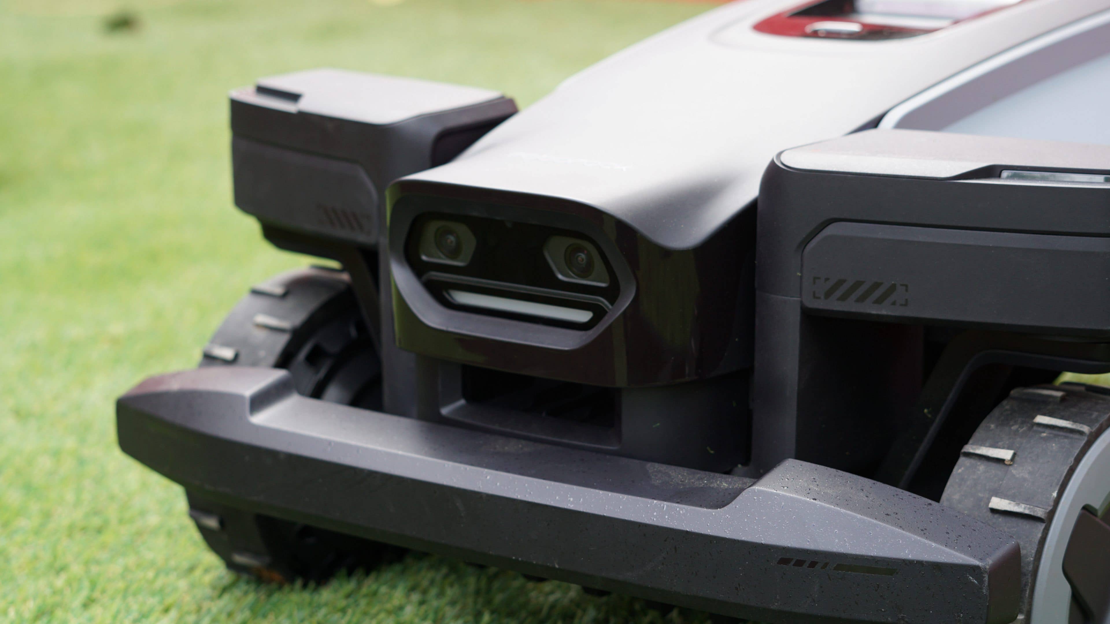 Close-up of the Roborock RockMow Z1 robotic lawn mower on grass. Close-up of the Roborock RockMow Z1 robotic lawn mower on grass.