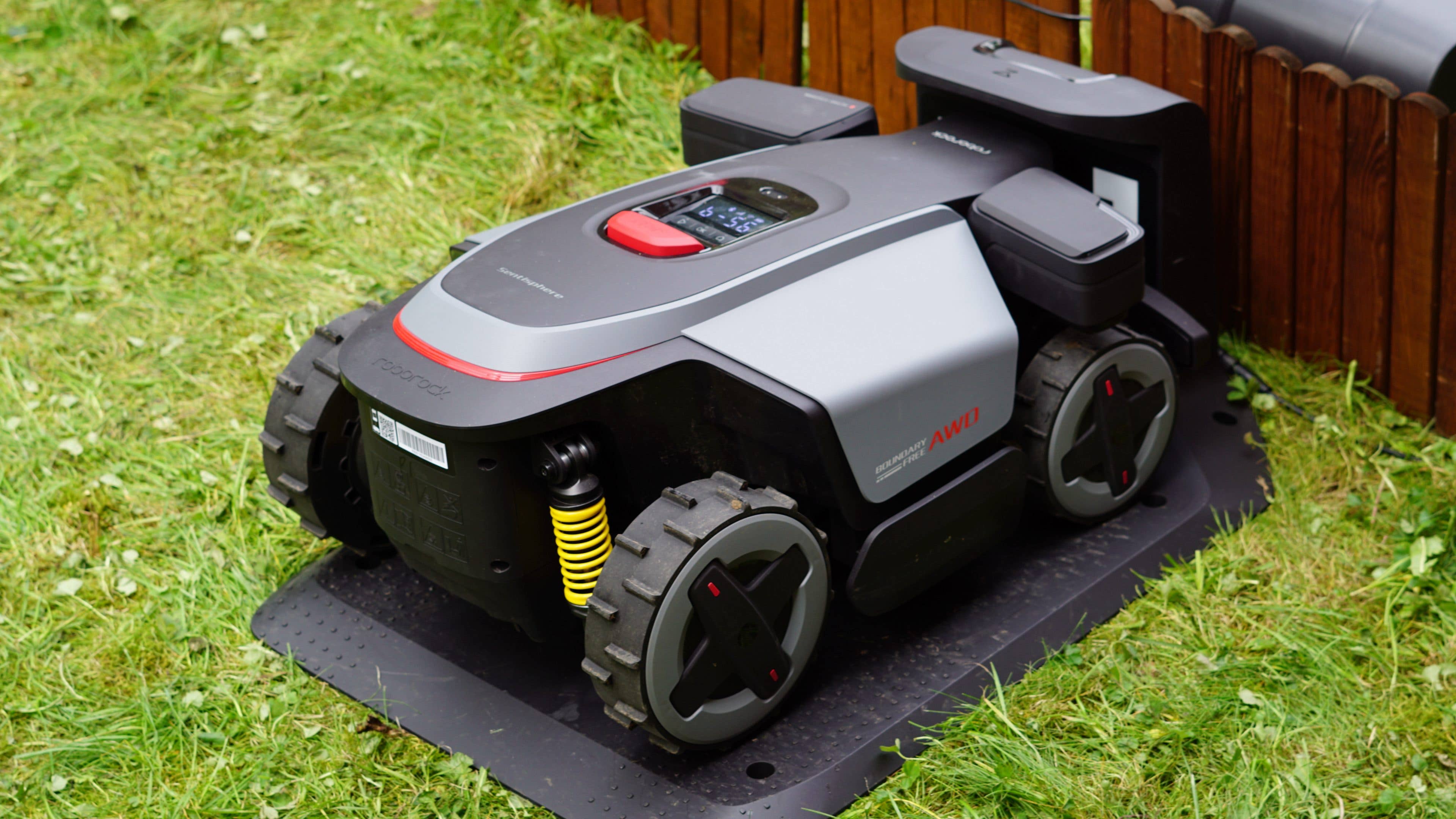 Roborock RockMow Z1 robotic lawn mower on a grassy area. Roborock RockMow Z1 robotic lawn mower on a grassy area.