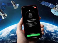 An iPhone floating in space surrounded by satellites with the Earth as a background