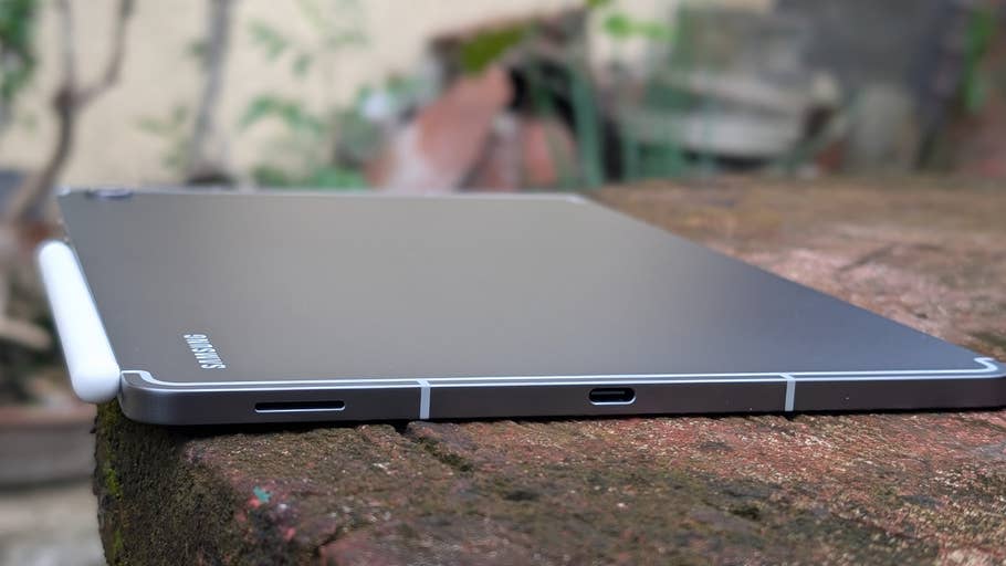 Samsung Galaxy Tab S10 FE lying flat on a surface with an S Pen attached.