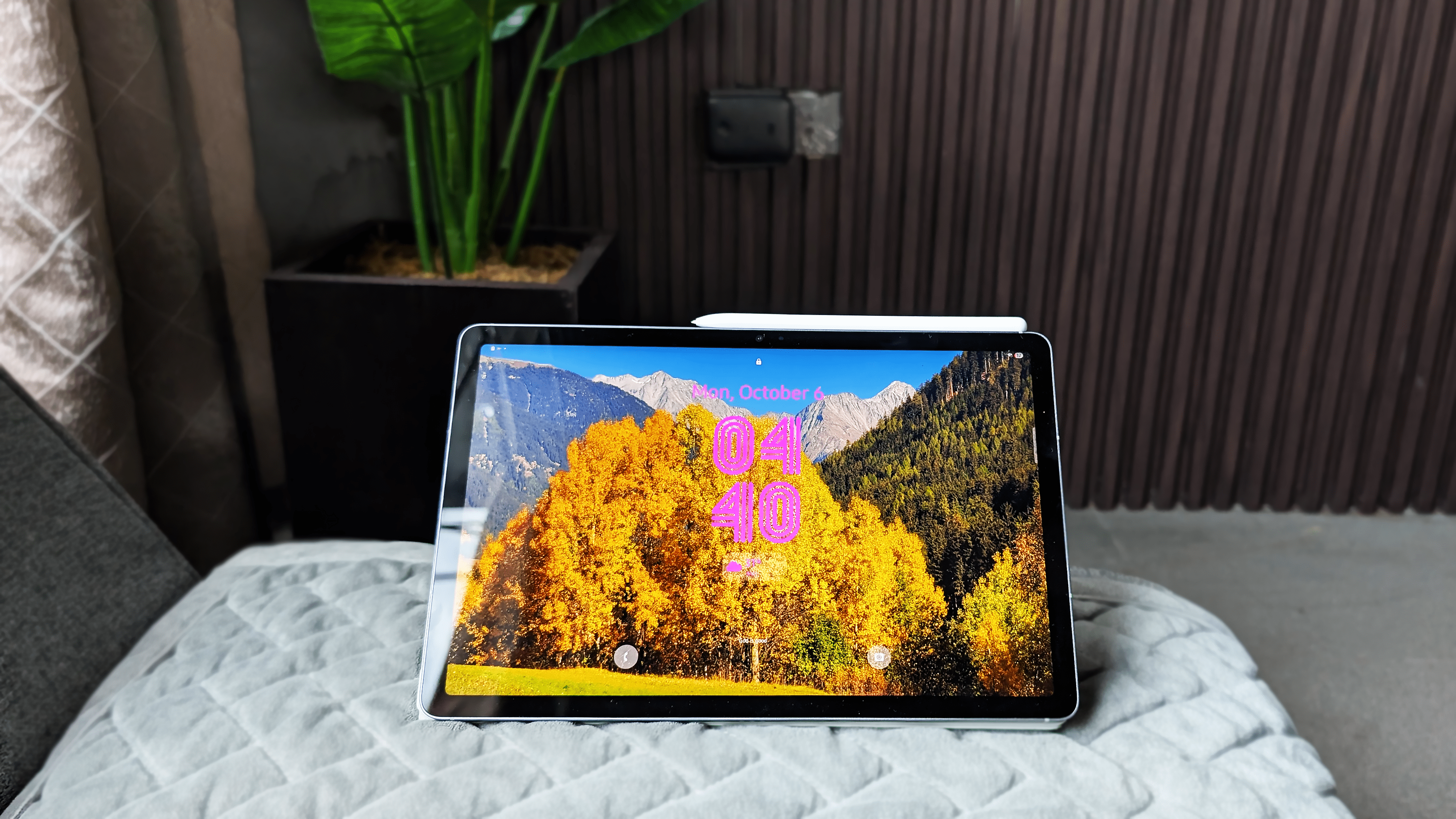 Samsung Galaxy Tab S10 FE displaying a scenic mountain and autumn trees wallpaper with the time 04:40.