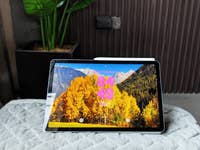 Samsung Galaxy Tab S10 FE displaying a scenic mountain and autumn trees wallpaper with the time 04:40.