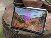 Samsung Galaxy Tab S10 FE showing a scenic mountain landscape on the screen.