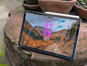 Samsung Galaxy Tab S10 FE showing a scenic mountain landscape on the screen.