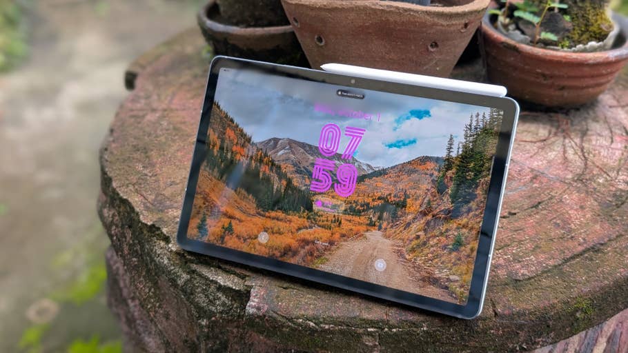 Samsung Galaxy Tab S10 FE showing a scenic mountain landscape on the screen.