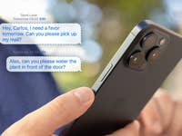 A person holding the iPhone 15 Pro Max and some messages popping up from it.