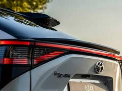 Close-up of a Toyota bZ4X rear, featuring the logo and sleek tail lights.