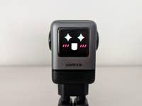 A Ugreen Uno 100W device with a smiling face on the screen.