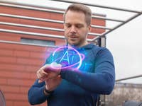A man using a smartwatch with a glowing 'AI' symbol, suggesting an AI coaching feature.