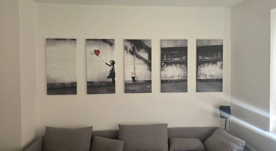 Five black and white wall art panels depicting a girl with a red balloon.