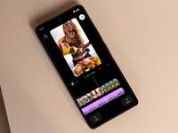 A smartphone displaying a video editing interface with food content and timeline features.
