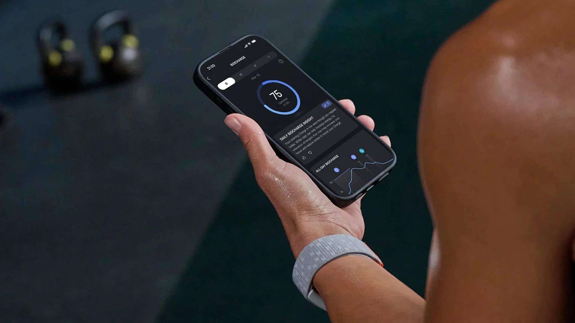 A person holding a smartphone displaying Amazfit fitness data.
