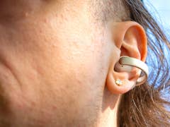 Close-up of a person with an Anker Soundcore Aeroclip earbud in their ear.
