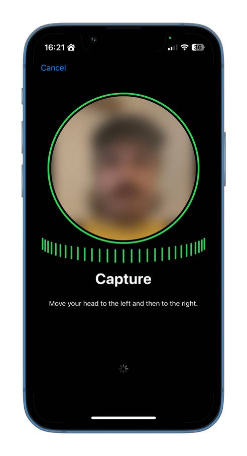 A smartphone screen displaying a face capture instruction with a blurred image.