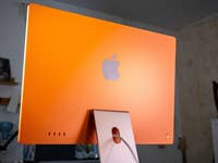 Orange Apple iMac M4 2024 from behind with visible Apple logo.
