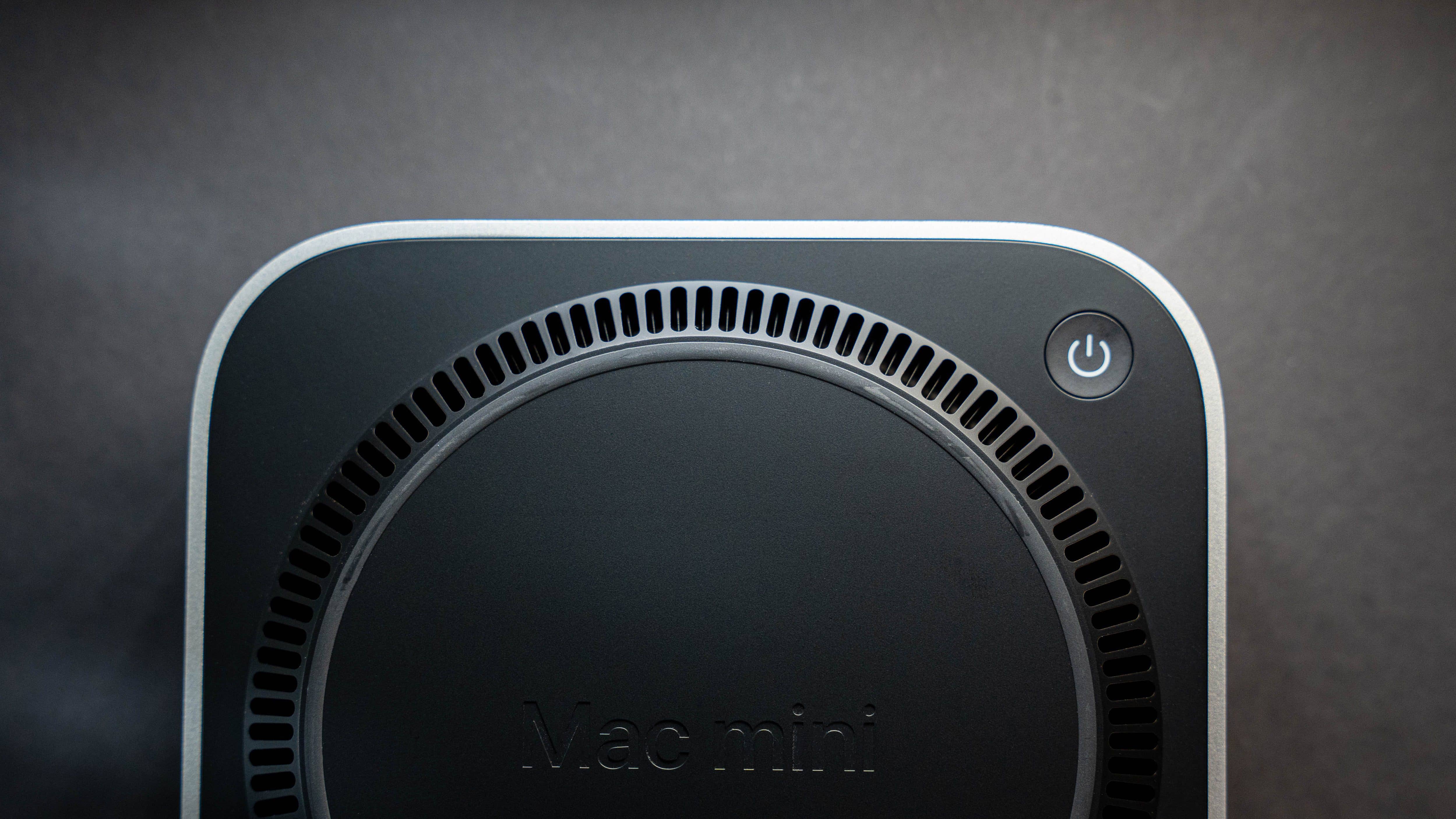Top view of an Apple Mac Mini M4 2024 with a power button and ventilation design.