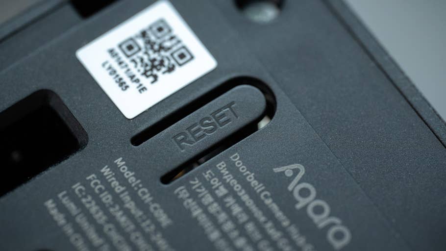 Close-up of the Aqara Doorbell Camera Hub G410 showing the RESET button and QR code.