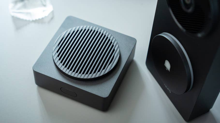 A close-up of the Aqara doorbell camera hub G410, featuring a round speaker with grooves and a black design.