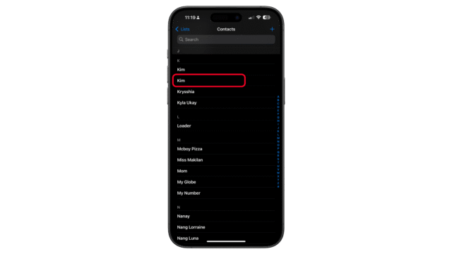 Go to the Contacts app and long press on the contact you want to delete. A contact list on an iPhone showing names with u0027Kimu0027 highlighted in red.