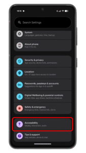 Tap on the Accessibility option. Settings menu of an Android device showing options like System, Security u0026 privacy, and Accessibility.