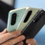 Even from the back, all three smartphones look almost identical. Three Samsung Galaxy A-series smartphones held by a person showing different colors u0026 camera design.