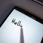 Writing works very well using the optional stylus! A Xiaomi Pad 7 shows the handwritten word u0027Hellou0027 on a lined background.