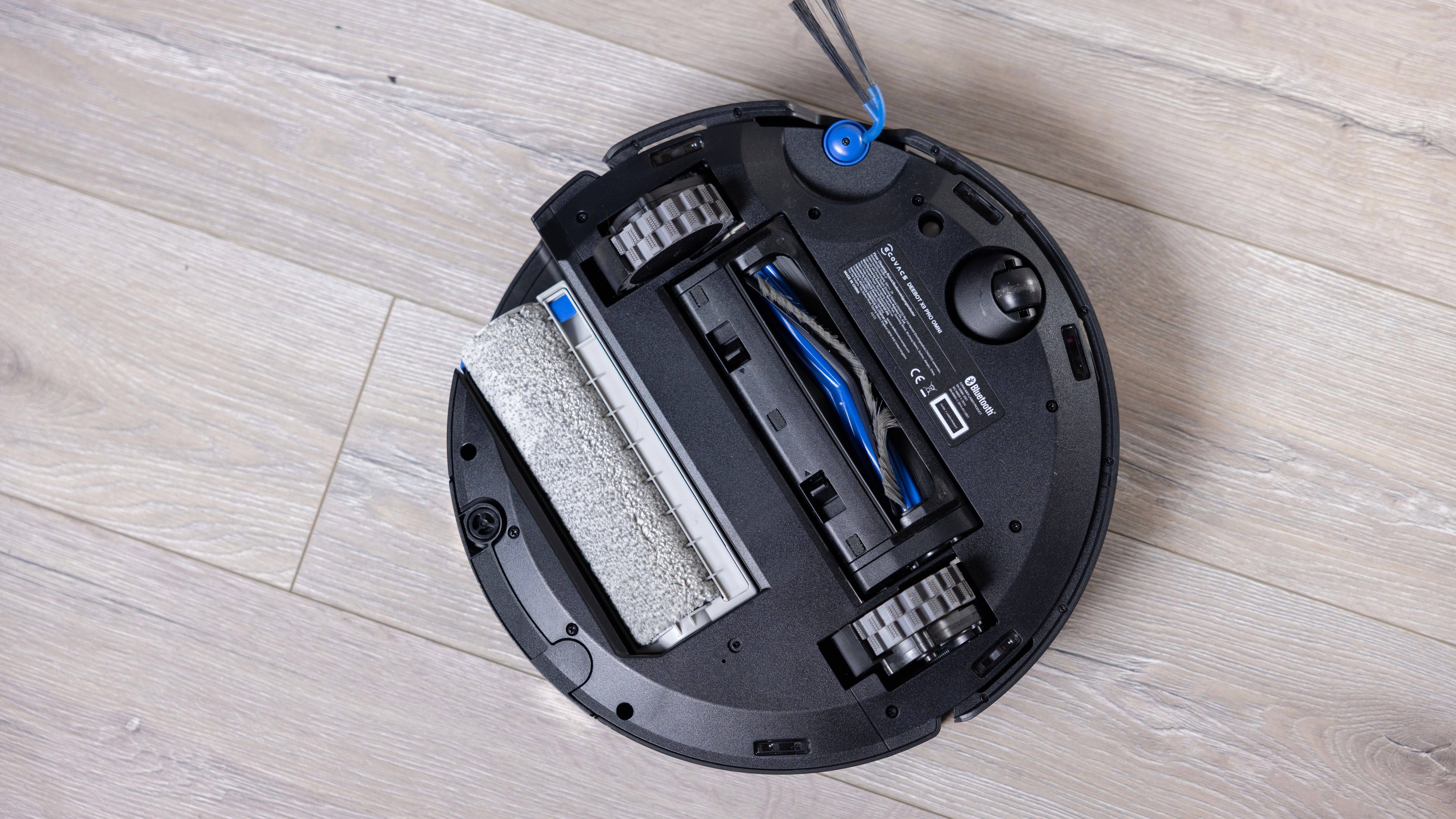 Top view of an Ecovacs Deebot X9 Pro vacuum cleaner with a cleaning roller and dust compartment.