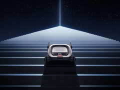 A eufy MarsRover ascending a staircase under a starry sky with a bright beam of light above.