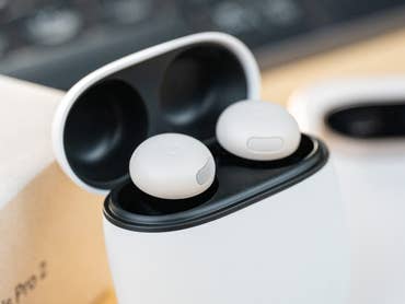 Google Pixel Buds Pro 2 inside their charging case, with a light background.