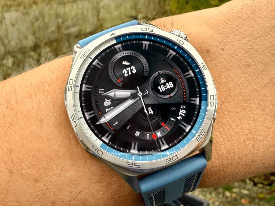 Huawei Watch GT 5 on a wrist displaying time and fitness metrics.