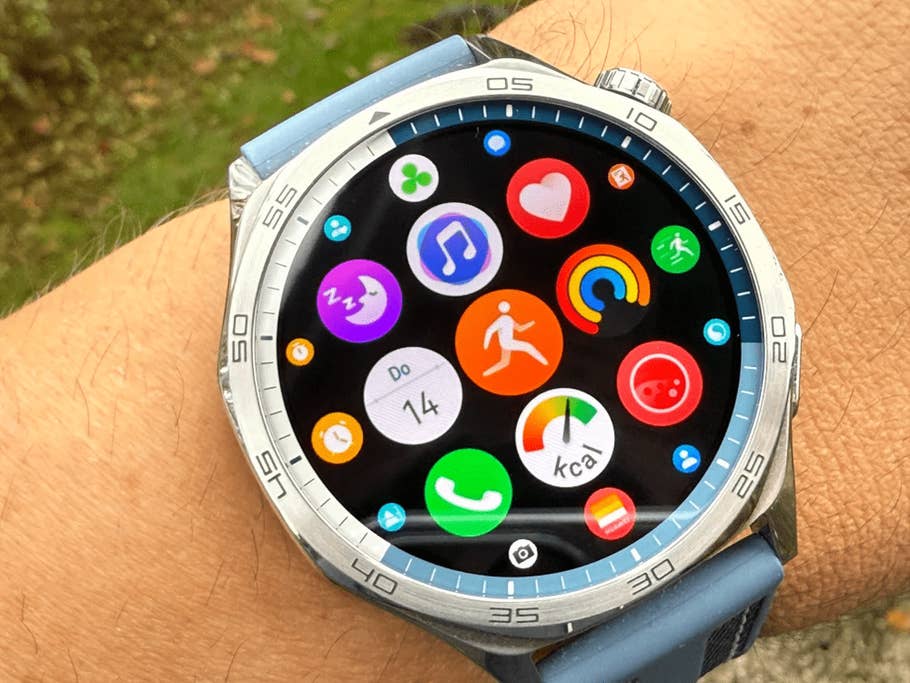 Close-up of a Huawei Watch GT 5 showing colorful app icons on its screen.