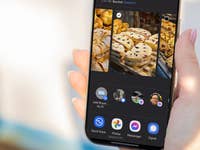 A person holding a smartphone displaying a selection of baked goods.