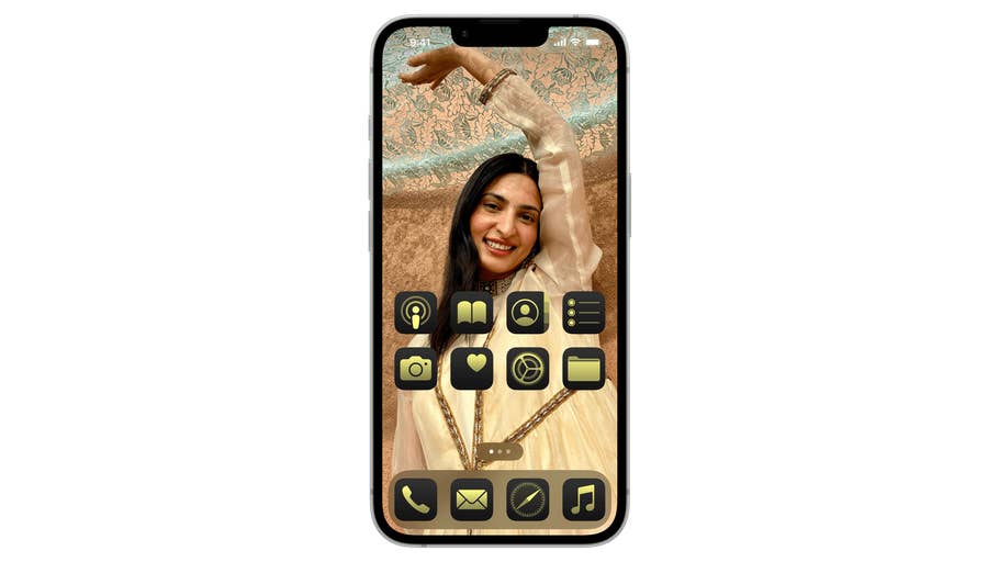 A smartphone displaying a woman smiling with a hand raised, featuring app icons on the screen.