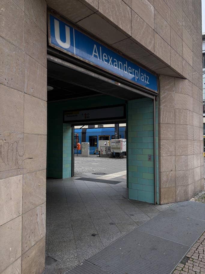 Entrance to the Alexanderplatz subway station with its tiled walls and signage.