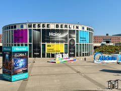 Messe Berlin with advertisements for IFA 2024, Haier, Hisense, and Midea in bright sunlight.