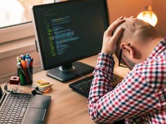 Man frustrated in front of a computer