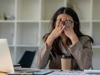 Person at a work desk looking frustrated