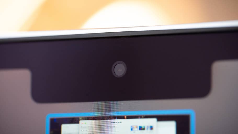 Close up of a MacBook Air M4 webcam with a blurry screen background.