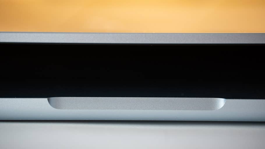 Close-up of an Apple MacBook Air with silver finish and blurred screen background.