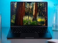 Apple MacBook Pro M4 with a forest wallpaper showing the time 12:04.