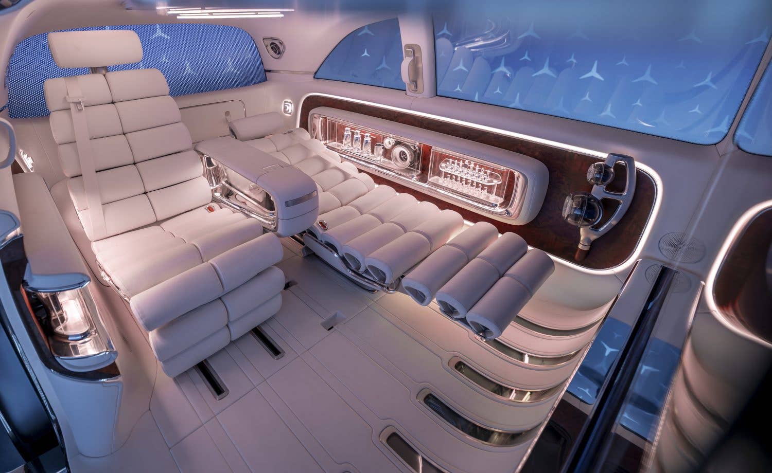 Interior of the Mercedes Vision V featuring luxurious white seating and sleek design elements.