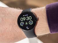 Front view of the Google Pixel Watch 2 worn on a straight wrist with its screen switched on.