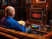 Casi sits on the couch in his 80s living room and watches Stranger Things