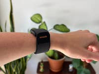 A close-up of a wrist with a black Amazfit Helio strap on it.