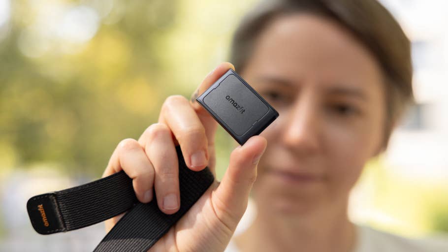 A person holds an Amazfit Helio strap in hand, showcasing its design.
