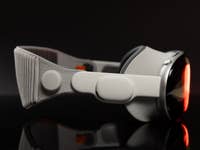 Apple Vision Pro headset viewed from the side against a dark background.