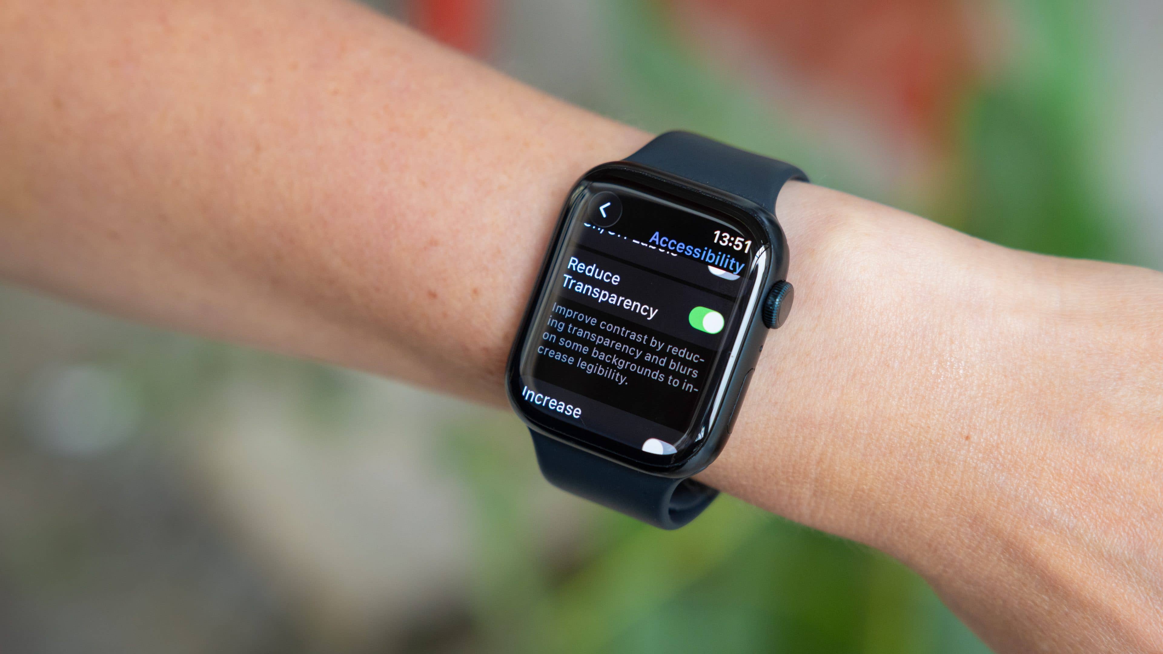 A person's wrist with an Apple Watch displaying accessibility settings.